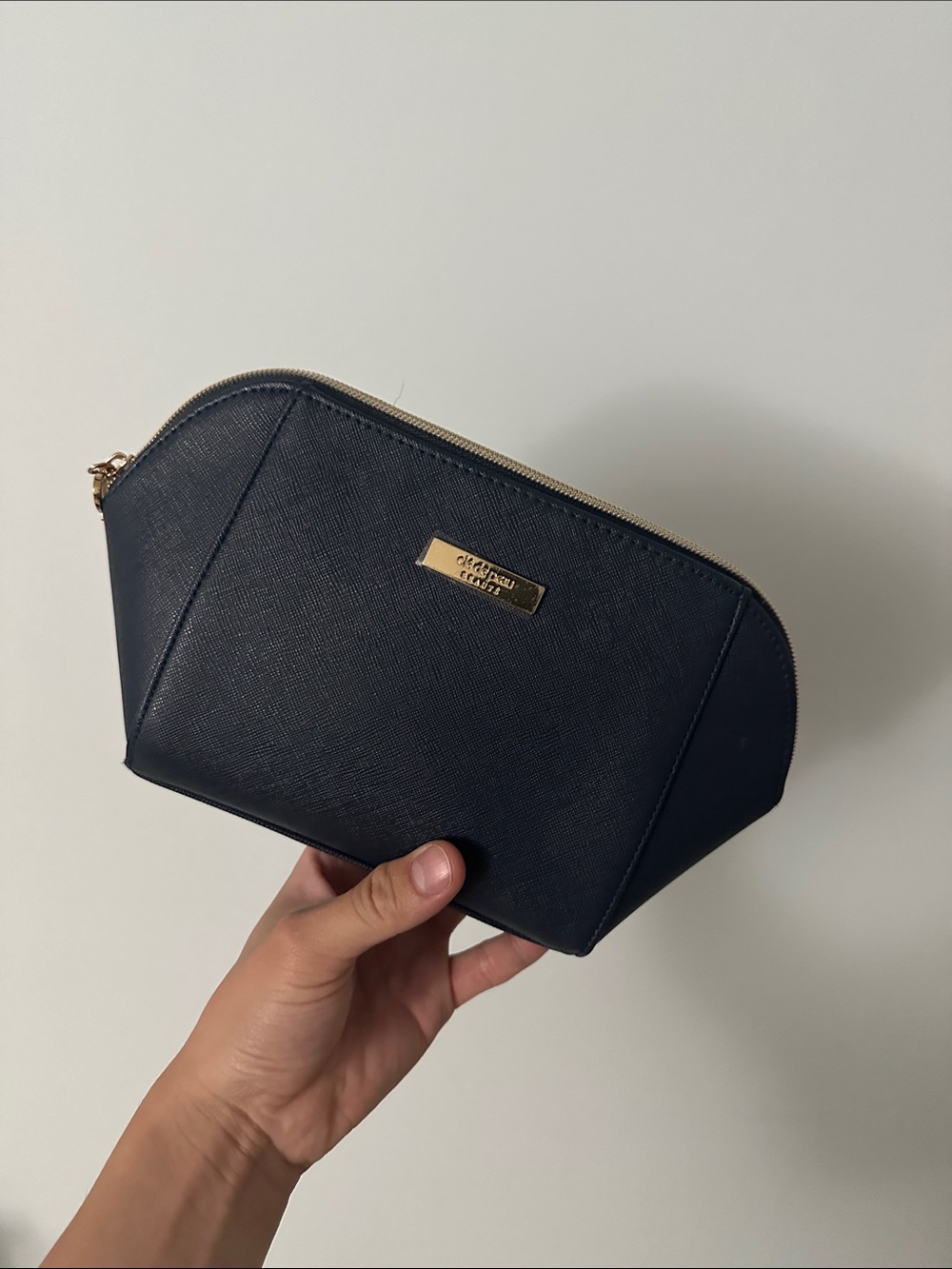 cle de Peau navy textured cosmetic pouch with gold hardware